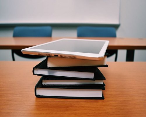 A tablet computer placed at an optimal reading distance on a modern table surface under balanced interior illumination